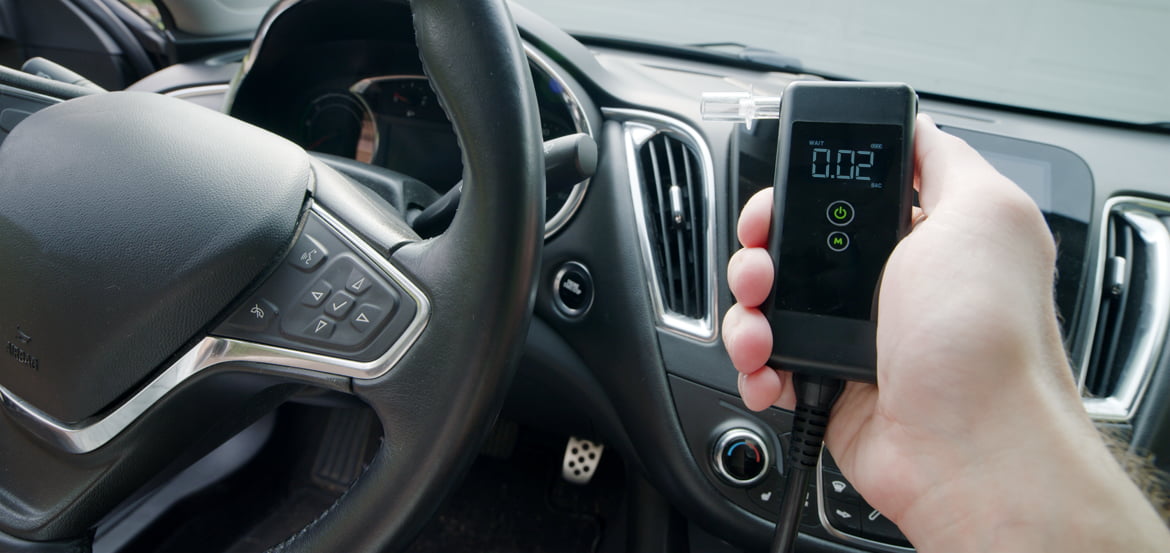 Small breathalyzer device inside a vehicle representing an ignition interlock with a reading of .02