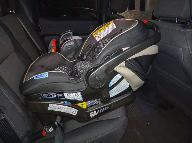 Car seat in the back of a vehicle where a child would sit