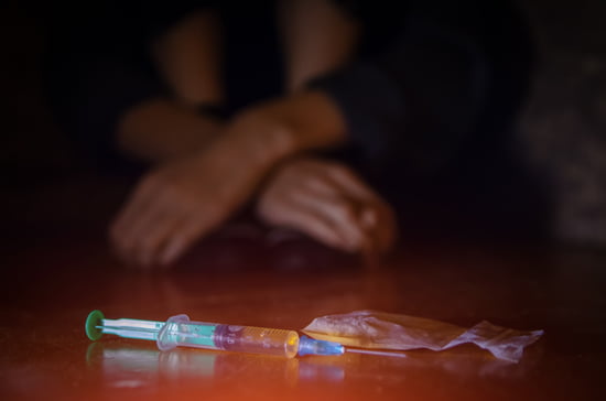 Syringes and other drug use devices on a table indicating the drug charge practice area