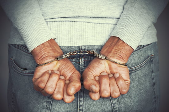 Closeup view of someone in handcuffs being arrested indicating the criminal defense practice area