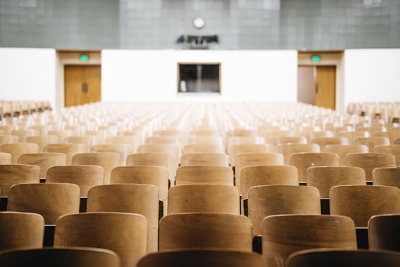 An empty school auditorium with rows of seats