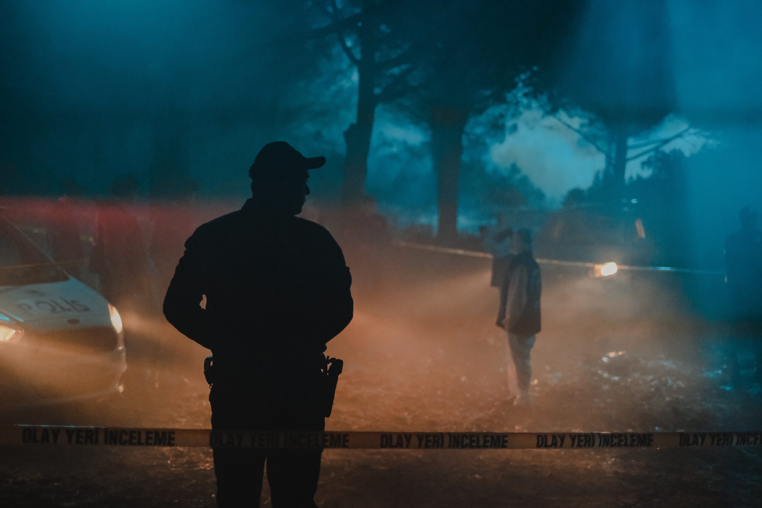 Police car and officer at sex crime location at night