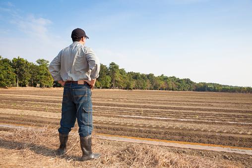 Michigan Stand Your Ground Law - male figure standing on his land with arms on waist.