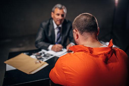 Featured: Probation officer at desk with defendant - Probation in Michigan