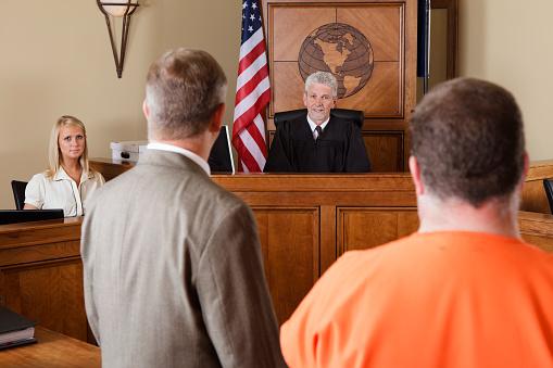 Featured: a sentencing hearing in a court with judge speaking to defendant and his lawyer- the sentencing process