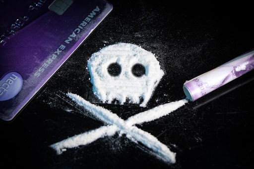 Featured: Skull and crossbones in white powder- Heroin Possession