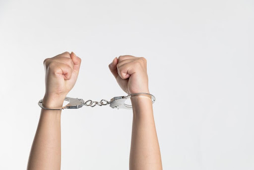 Featured: Clinched handcuffed arms raised in the air- Resisting Arrest in Michigan