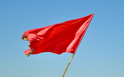 Featured: Red flag with burnt edge- Red Flag Laws in Michigan: What You Should Know