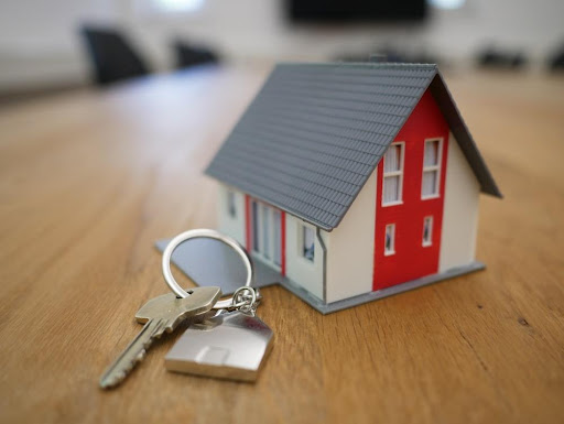 Featured: Padlock on small house model on desk- Collateral Consequences of a Criminal Conviction