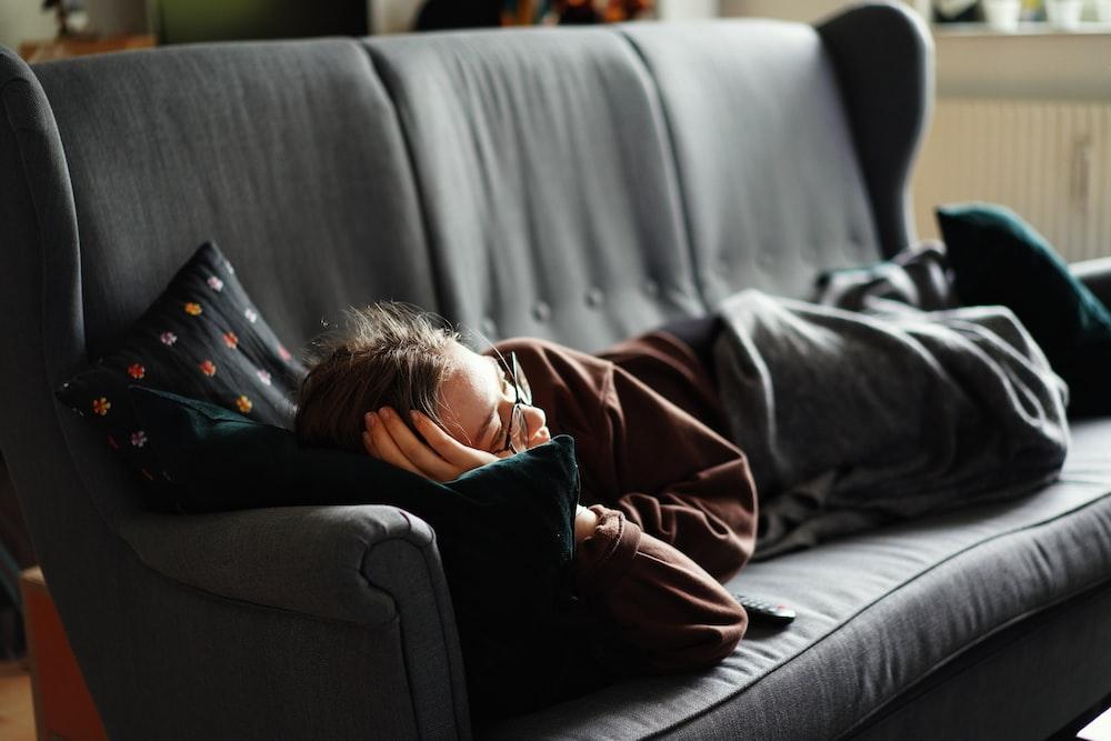 Featured: Person laying down on black sofa - Are Misdemeanors Actually a Big Deal?